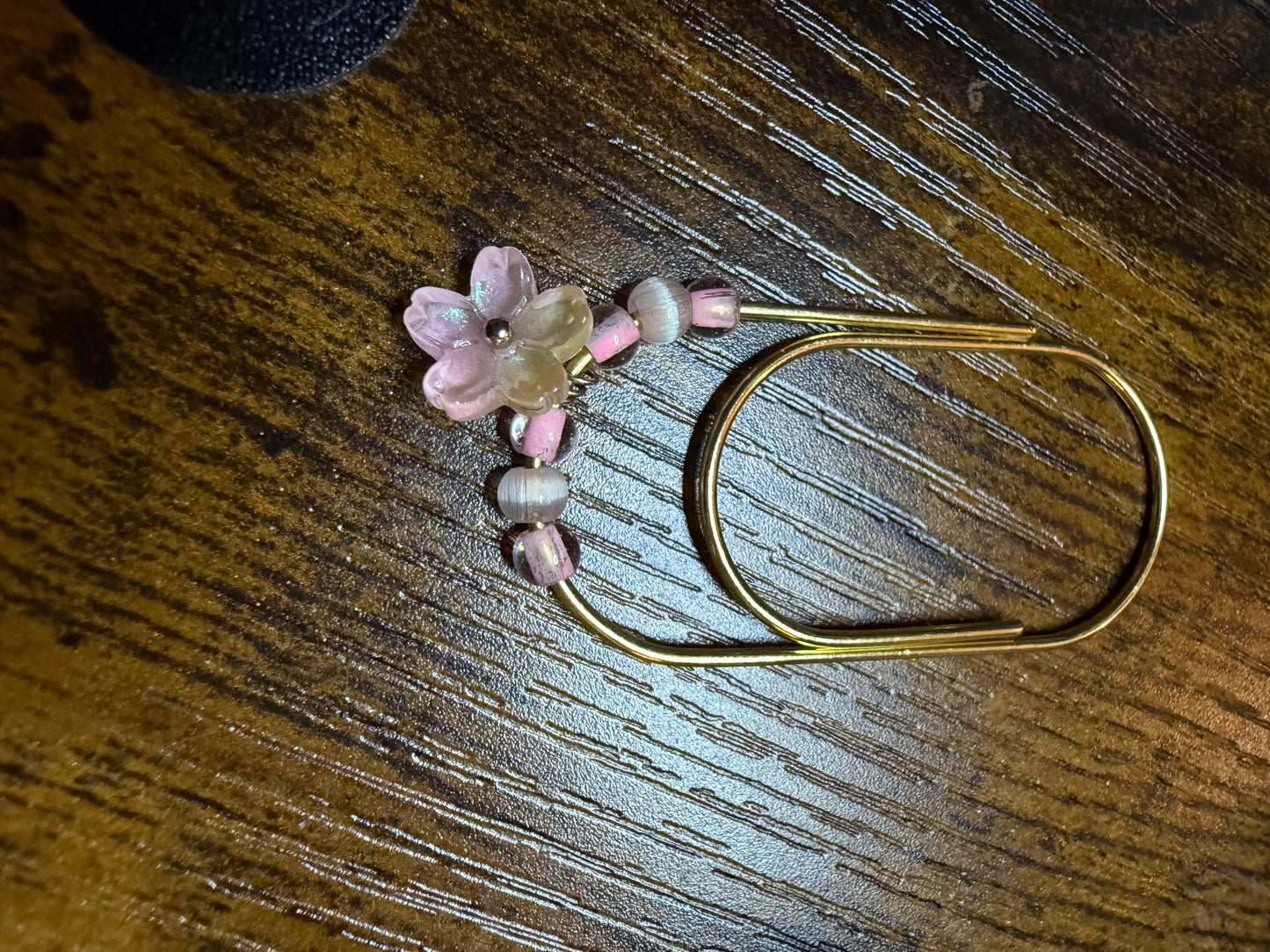 Pink glass and metal paperclip